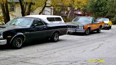 1973 Ford Ranchero - Three Ford Rancheros are parked in a row on a residential street.