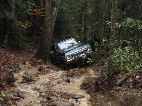 1985 Ford Bronco - This truck is stuck in a muddy stream on a forest trail.