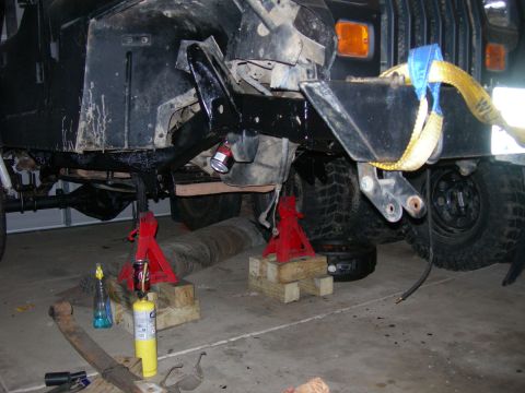 1991 Jeep Wrangler - This Jeep Wrangler is elevated on jack stands, revealing modifications to its front end, including a D60 axle swap.