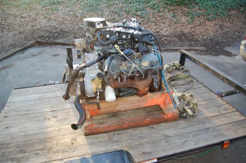 1994 Ford Bronco - Engine assembly on a wooden pallet on a trailer, ready for transport.
