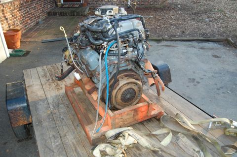 1994 Ford Bronco - A V8 engine is loaded onto a trailer, ready for transport.