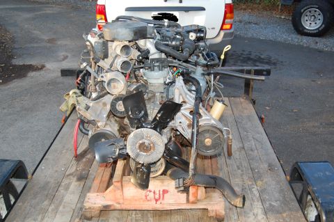 1994 Ford Bronco - Engine assembly on a trailer, with visible hoses and belts.