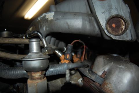 1994 Ford Bronco - The image shows a close-up view of fuel injectors and associated engine components.