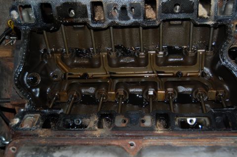1994 Ford Bronco - Close-up view of an engine's cylinder head, revealing the internal valve train components.
