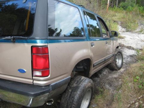 1992 Ford Explorer - This lifted Ford Explorer navigates a challenging muddy off-road path.