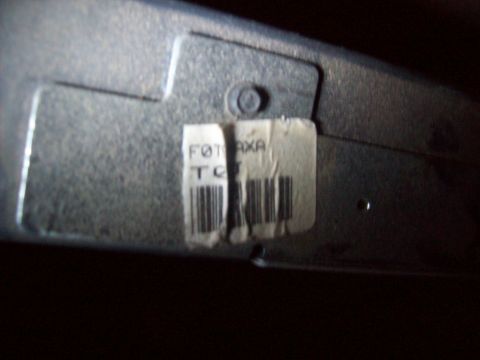 1985 Ford Bronco - A metal component with a label containing text and barcodes is visible.