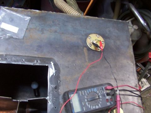 1995 Ford C-350 (Centurion Conversions) - Testing a fuel tank sender unit with a multimeter, likely for a custom installation.