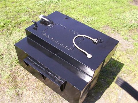 1995 Ford C-350 (Centurion Conversions) - A custom-built fuel tank sits on the grass, showing its various fittings and construction.