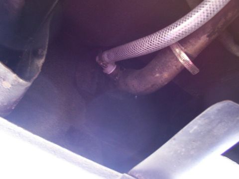 1995 Ford C-350 (Centurion Conversions) - A close-up view of a hose connected to a pipe, likely part of a custom fuel tank setup.