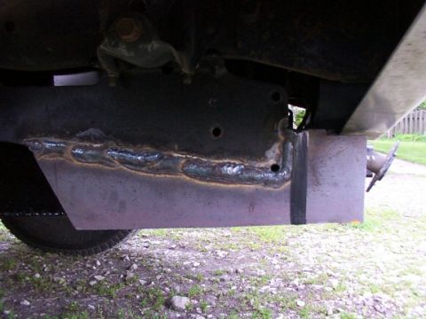 1995 Ford C-350 (Centurion Conversions) - Custom metalwork, likely a bracket or reinforcement, welded onto a vehicle's frame.
