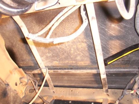 1995 Ford C-350 (Centurion Conversions) - Underside view of vehicle components, including wiring and structural elements.