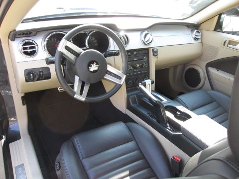 1996 Ford Bronco - Interior of a 2005 Ford Mustang, black leather seats and a modern dashboard layout.