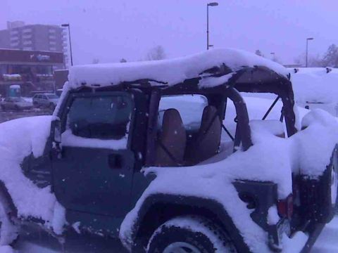 2008 Jeep Wrangler - A Jeep Wrangler is heavily covered in snow during a winter storm.
