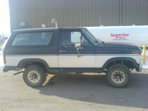 1985 Ford Bronco - This 1985 Ford Bronco features a classic two-tone paint scheme with dark blue on top and white on the bottom.
