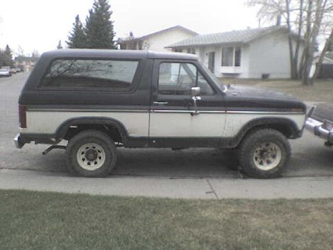 1985 Ford Bronco - This 1985 Ford Bronco is shown from the side, parked on a suburban street.