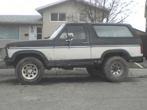 1985 Ford Bronco - This two-tone Ford Bronco is shown from the side, a black roof and white lower body panels.