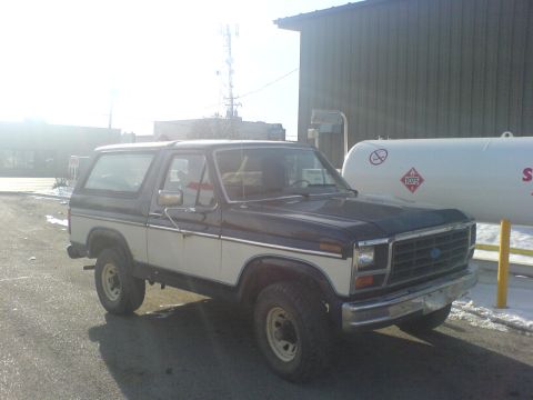 1985 Ford Bronco - This 1985 Ford Bronco features a two-tone paint scheme with dark blue and white sections.