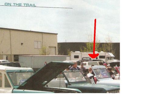 1995 Ford Bronco - Several vehicles are parked outside a building, with an RV visible in the background.