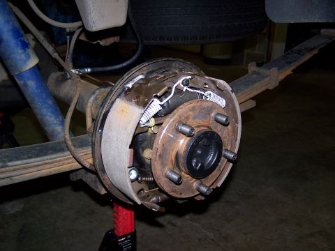 1991 Jeep Comanche - Close-up view of a rear drum brake assembly, showing the brake shoes, springs, and drum.