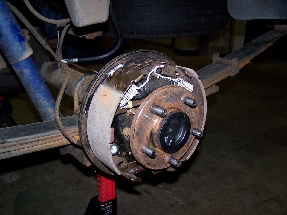 Rear drum brake assembly with leaf springs and blue shock absorber