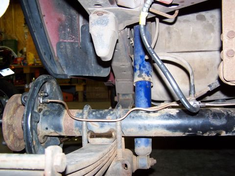 1991 Jeep Comanche - Close-up view of the rear axle and suspension system of a vehicle.