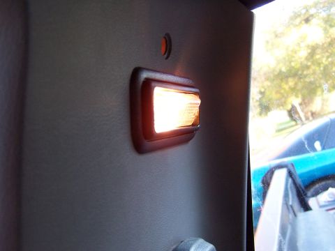 1991 Jeep Comanche - Interior dome light is on, showing a glimpse of another vehicle outside.