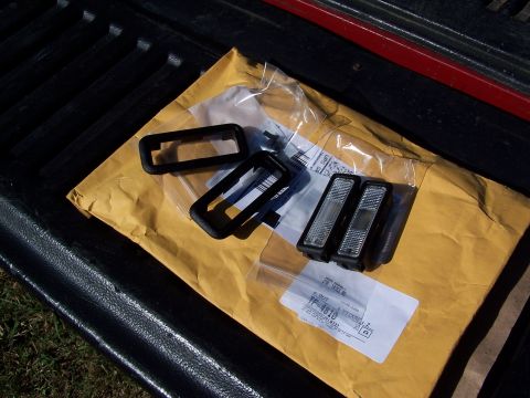 1991 Jeep Comanche - New marker lights and bezels are laid out on a shipping envelope in the bed of a truck.