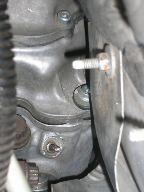 1979 Chevrolet C/K Pickup - Detail of an engine part, showing bolts and metallic surfaces.