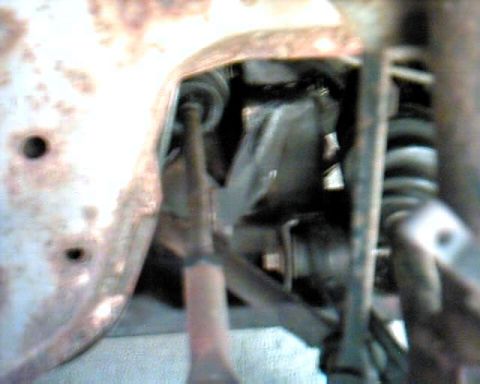 1990 Ford Taurus - Undercarriage view of suspension components, likely from a car or truck.