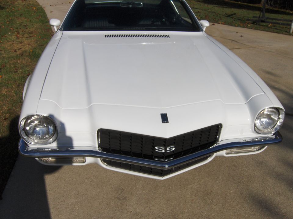 Front view of a white 1970s Chevrolet Camaro SS with a black grille and SS badge