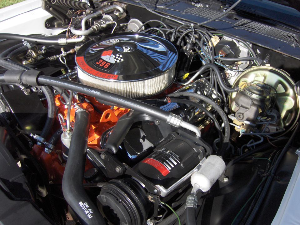 Engine bay with chrome air cleaner showing '396 350 HP' and checkered flag badge