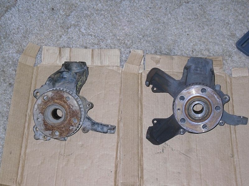 Two used wheel hubs on cardboard