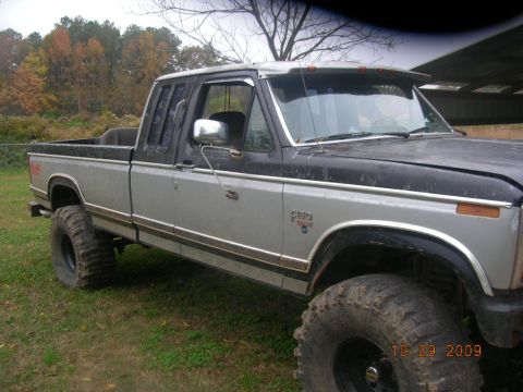1991 Ford F-150 - This lifted 1991 Ford F-150 pickup truck features a two-tone paint scheme and aggressive off-road tires.