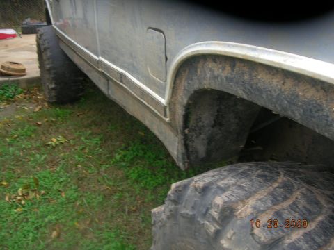 1991 Ford F-150 - This lifted truck features oversized tires and a side view that highlights its substantial ground clearance.