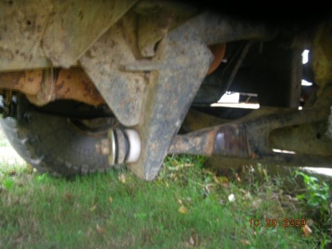 1991 Ford F-150 - Close-up view of the undercarriage of a 1991 Ford F-150, highlighting suspension parts and a tire.