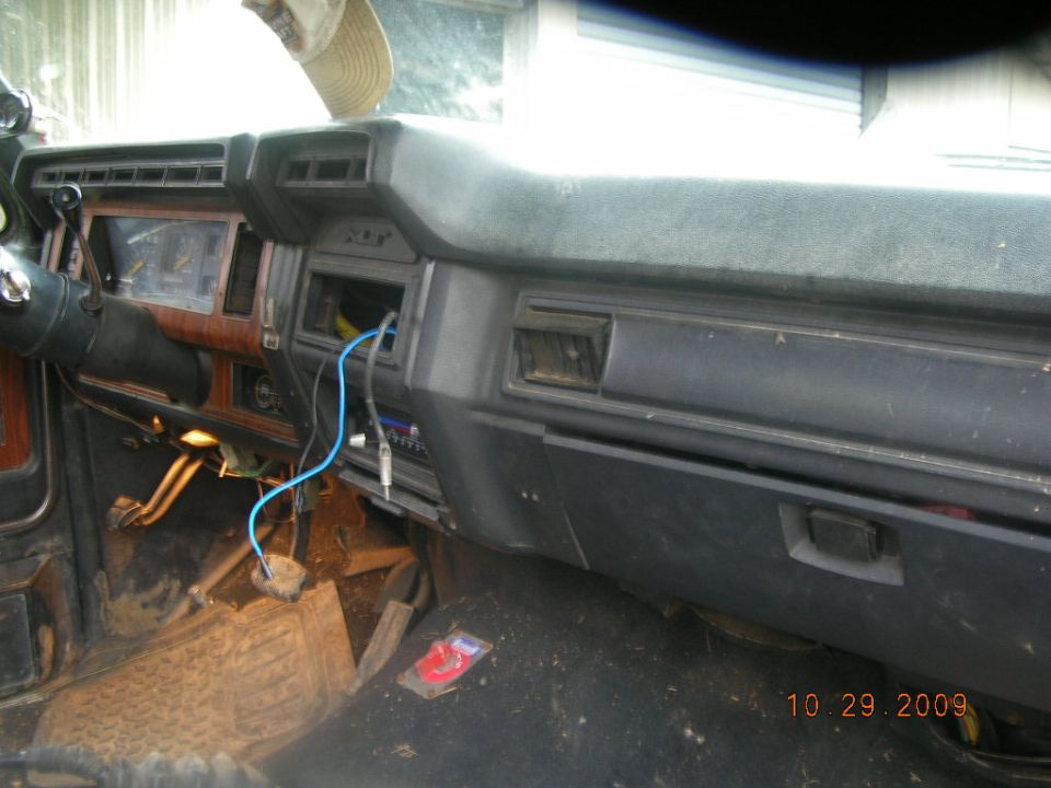 Gray XLT truck dash with woodgrain trim, gauges and empty radio opening
