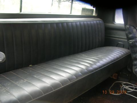 1991 Ford F-150 - Interior view of a 1991 Ford F-150, showing the black vinyl bench seat and rear window.