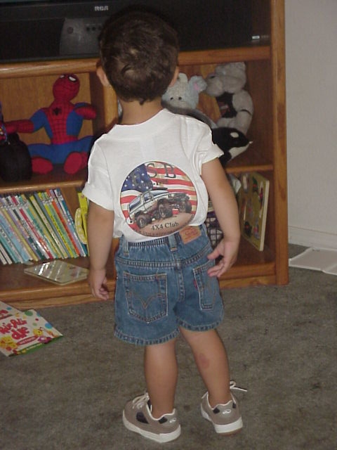 1989 Ford Bronco - A child's t-shirt features a graphic of a 4x4 truck with an American flag background.