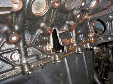 2007 Ford Mustang - Engine block shows significant damage and corrosion, with a large breach in its structure.