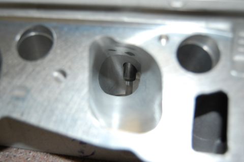 2007 Ford Mustang - Close-up view of an engine cylinder head, showing internal porting and valve seat area.