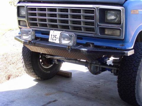 1980 Ford Bronco - Front view of a blue truck, possibly a 1979 model, a custom diamond plate bumper and auxiliary lighting.