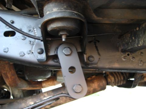 1989 Ford Bronco - Undercarriage view of a vehicle's frame, showing suspension and exhaust system parts.