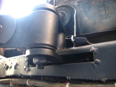 1989 Ford Bronco - Detail of a vehicle's suspension system, showing a bolted component and frame structure.