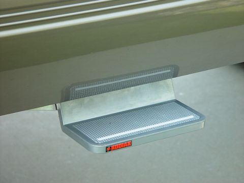 2001 Ford Excursion - A close-up of a Kodiak brand step attached to the lower body of a vehicle.