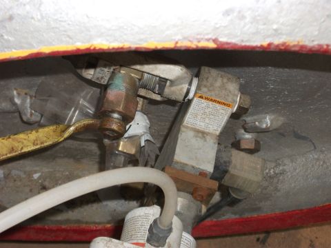 1992 Ford F-150 - A warning label is attached to a metal component with various pipes and fittings.