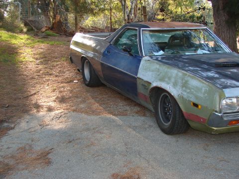 1973 Ford Ranchero - This Ford Ranchero shows significant body damage and unfinished repairs, with parts in primer and rust visible.