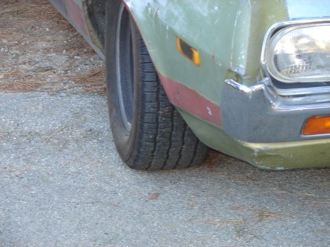 1973 Ford Ranchero - Close-up view of the front corner of a vehicle, showing the tire and bumper detail.