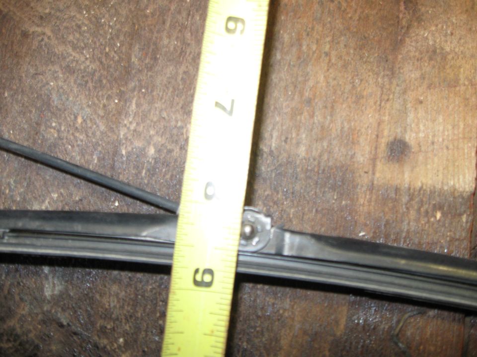 close-up of a windshield wiper blade with a tape measure showing it is about 9 inches long
