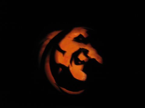 1968 Ford Mustang - A carved jack-o-lantern glows in the dark, its eerie face illuminated by an internal light source.