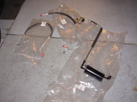 1995 Ford Taurus - This image shows a power steering hose assembly, likely for a vehicle, laid out on a concrete floor.